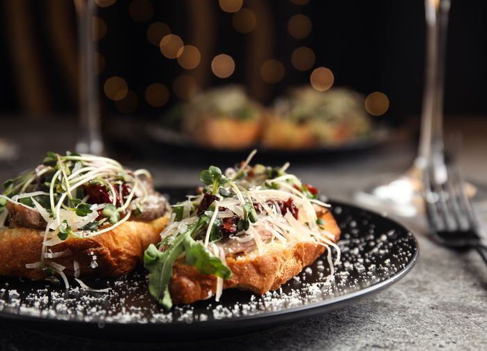 Bruschetta dish with sausages and cheese